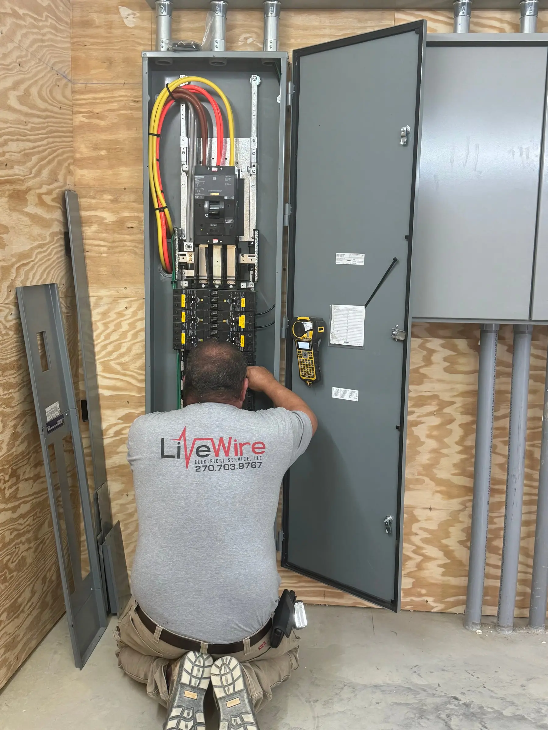 LiveWire Electrical Service electrician wiring a commercial electrical panel in Benton, KY