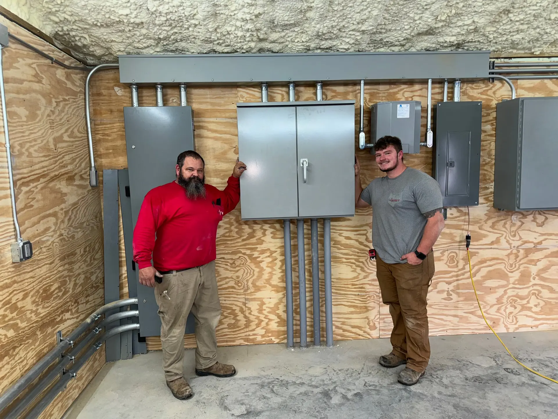 LiveWire Electrical Service electricians with a completed electrical panel installation